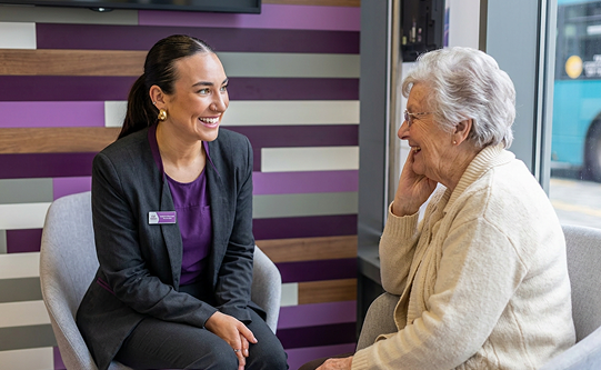 A Kent Reliance colleague talking with a customer in branch